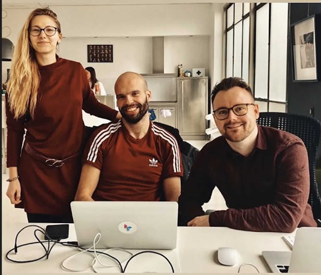 Ben with two colleagues at a desk